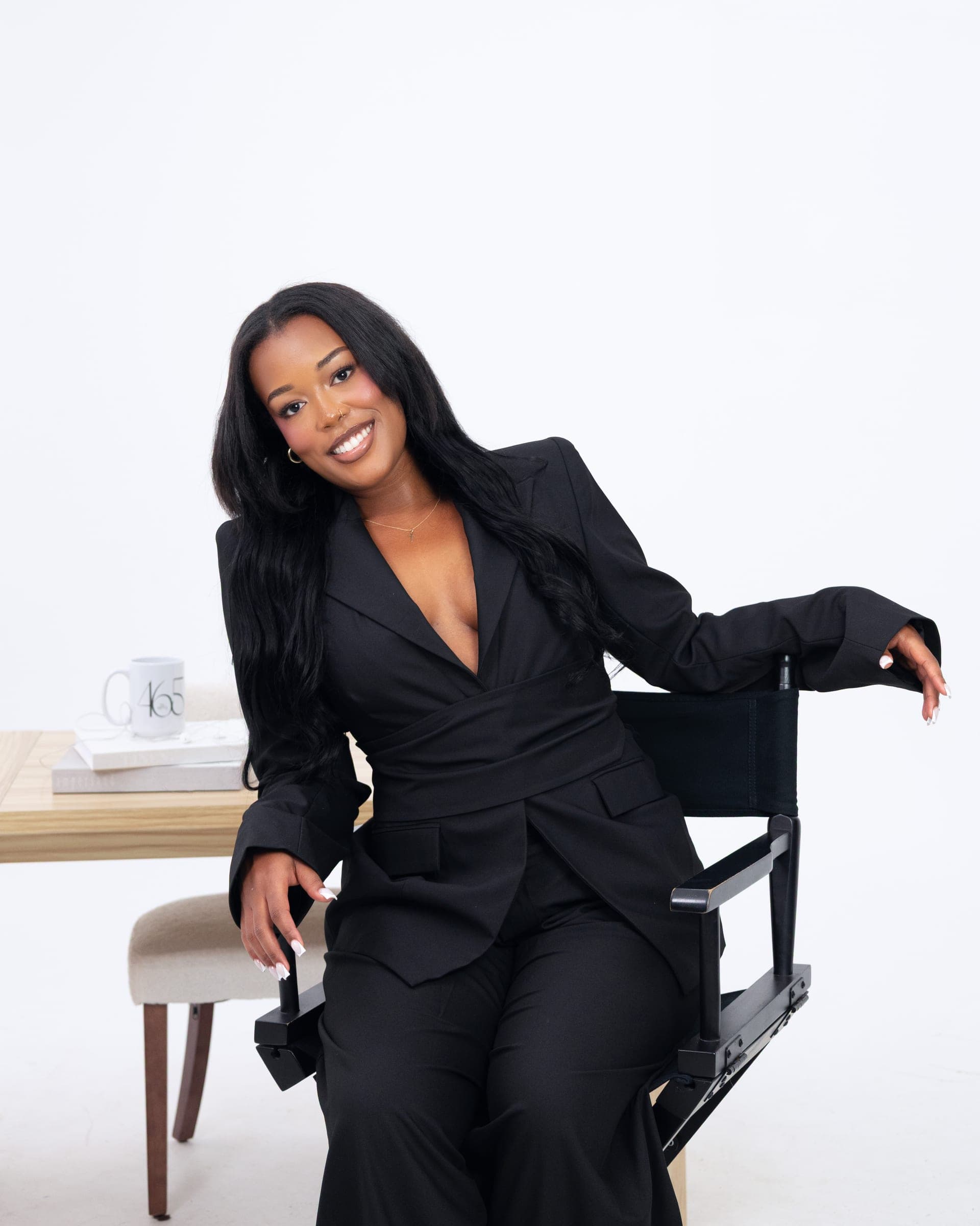 Audrey, founder of 465 The Agency, seated in a director's chair