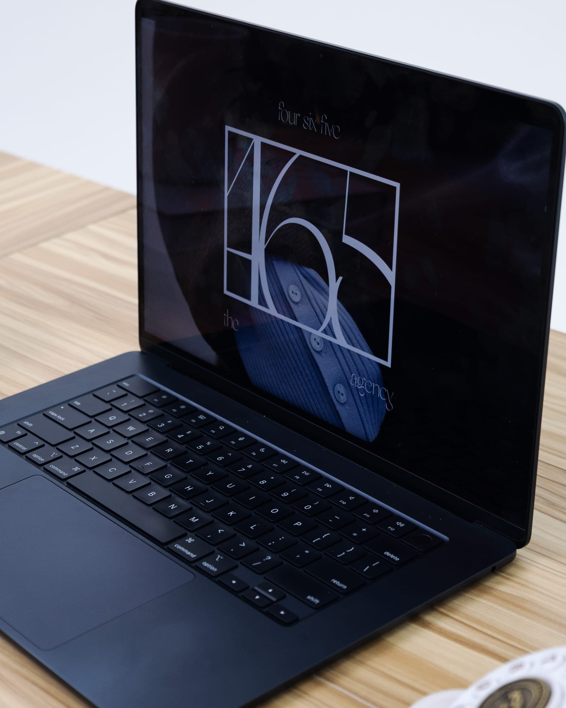 The 465 brand identity glowing on a laptop screen in the studio